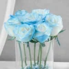 Glass vase with blue roses and baby’s breath fillers wrapped in jute – elegant floral gift for Father’s Day