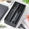 Black personalized office gift box with bottle, pen, and keychain