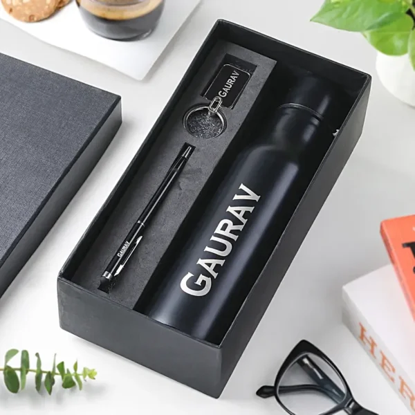 Black personalized office gift box with bottle, pen, and keychain